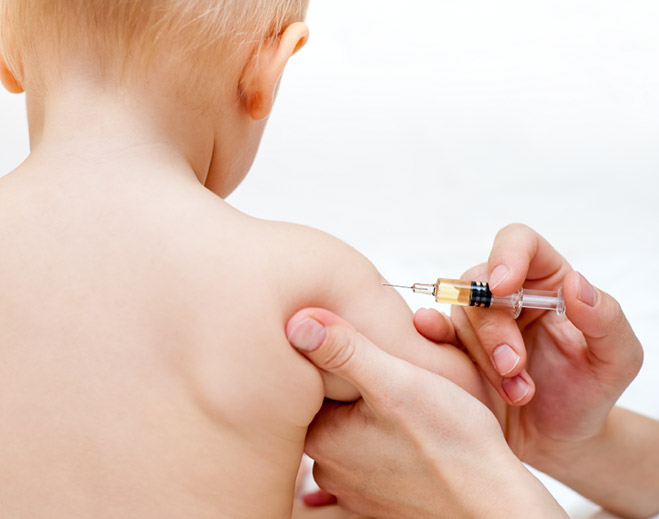 Baby receiving shot in healthcare setting