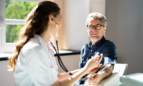 Doctor checking patient’s blood pressure