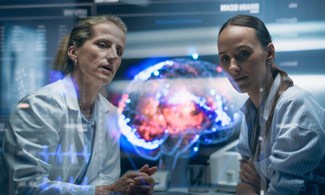 Doctors reviewing brain imaging display