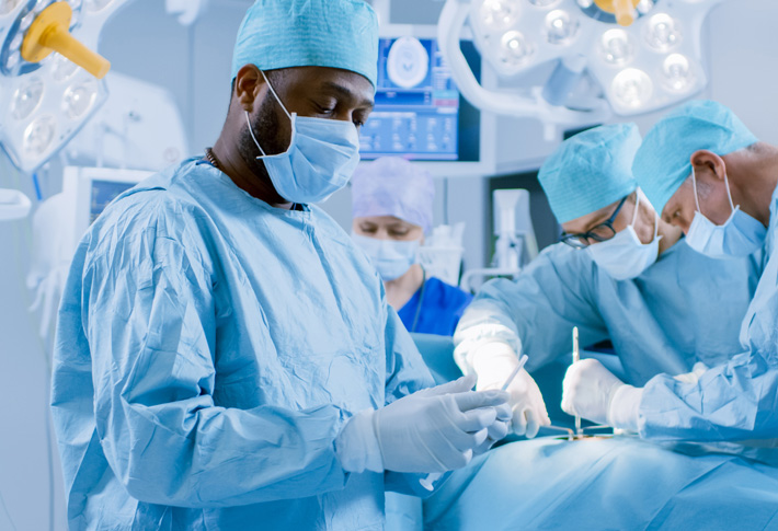 Surgeons performing procedure in operating room