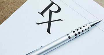 Prescription pad with pen on table
